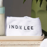 Indie Lee white absorbent headband for washing face or applying skincare