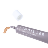 Swatch of Indie Lee Bronzing Drops next to product on a white background