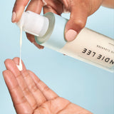Woman squeezing Indie Lee CoQ-10 Cleanser onto her hand