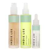 Bottles of Indie Lee Brightening Cleanser, CoQ-10 Toner, and Squalane Facial Oil on a white background