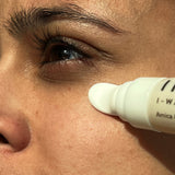 Woman applying Indie Lee I-Waken Eye Serum