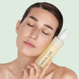 Woman holding Bottle of Indie Lee Soothing Cleanser