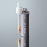 Bottle of Indie Lee SPF 50 Sunscreen Primer with product shown in dropper applicator