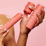 Woman holding Bottle of Indie Lee Retinol Alternative Cream