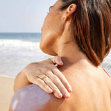 Woman applying Indie Lee Mineral Sunscreen