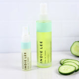 Two bottles of Indie Lee COQ-10 Toner with cucumber slices on a white background