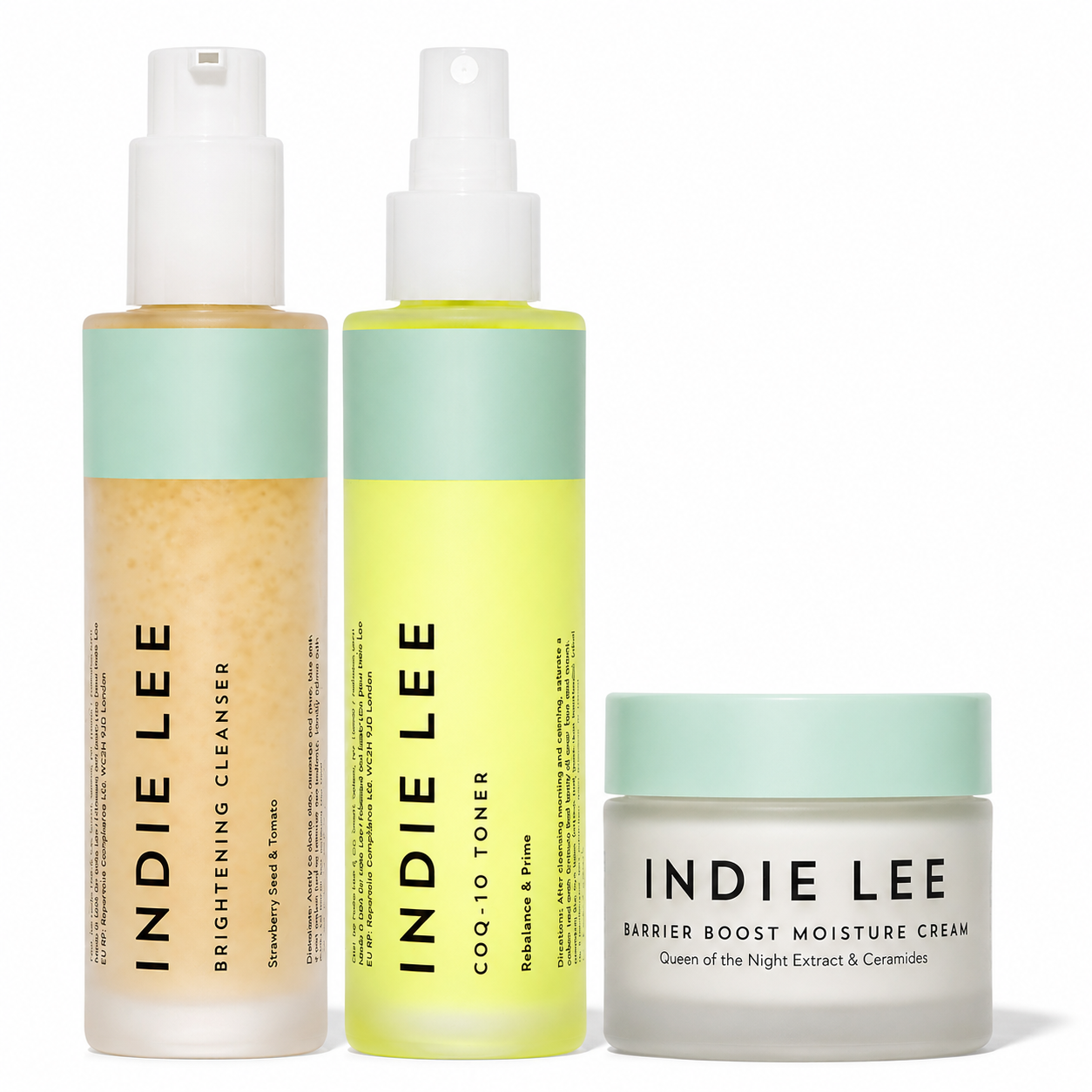 Three Indie Lee skincare products on a white background: a Brightening Cleanser bottle, a COQ-10 Toner spray bottle, and a Barrier Boost Moisture Cream jar.