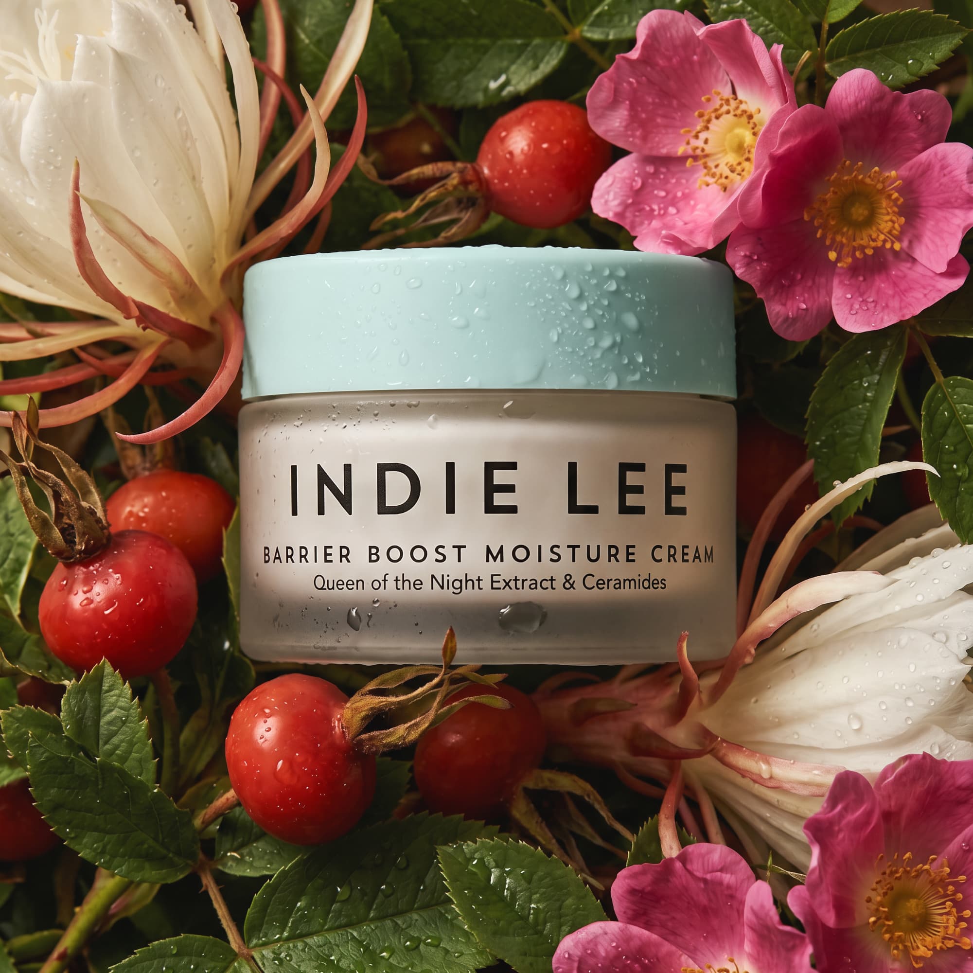 Jar of Indie Lee Barrier Boost Moisture Cream on a background of flowers and leaves