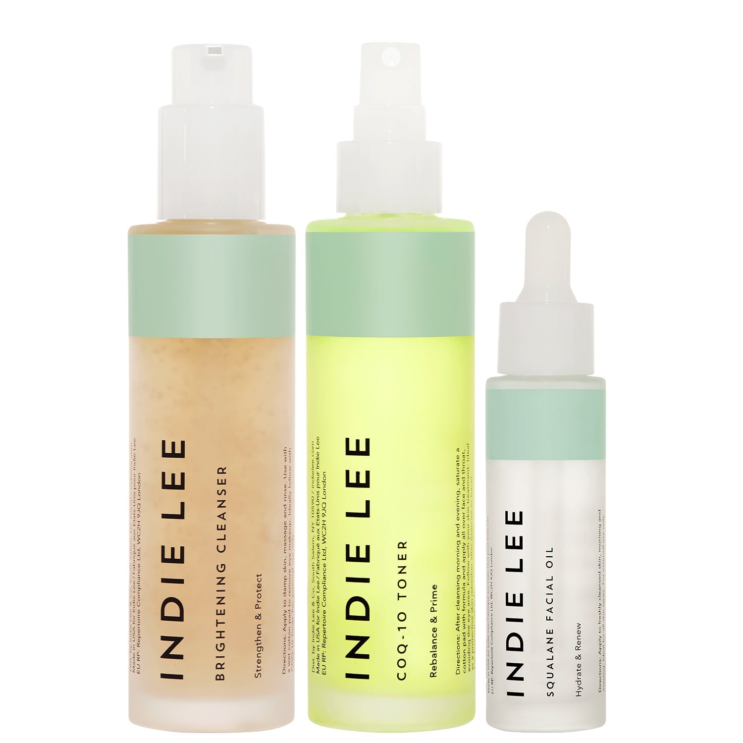 Bottles of Indie Lee Brightening Cleanser, CoQ-10 Toner, and Squalane Facial Oil on a white background