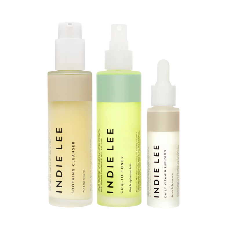 Three bottles of Indie Lee skincare products on a white background