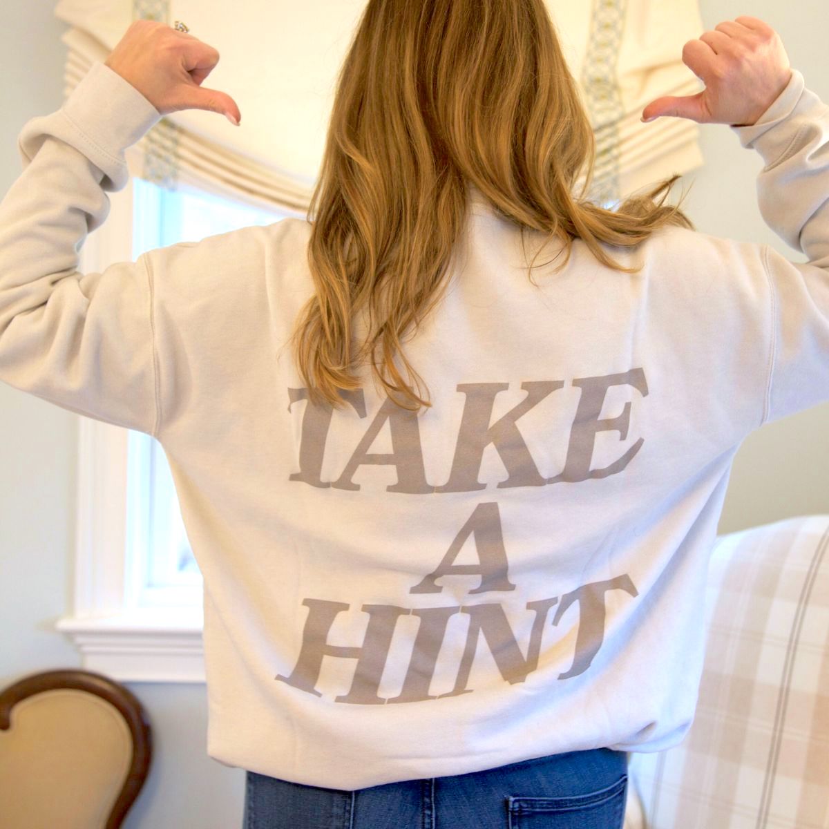 Woman wearing Indie Lee "Take A Hint" Sweatshirt