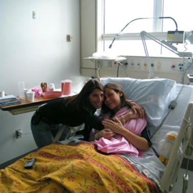 Indie Lee recovering in a hospital patient bed