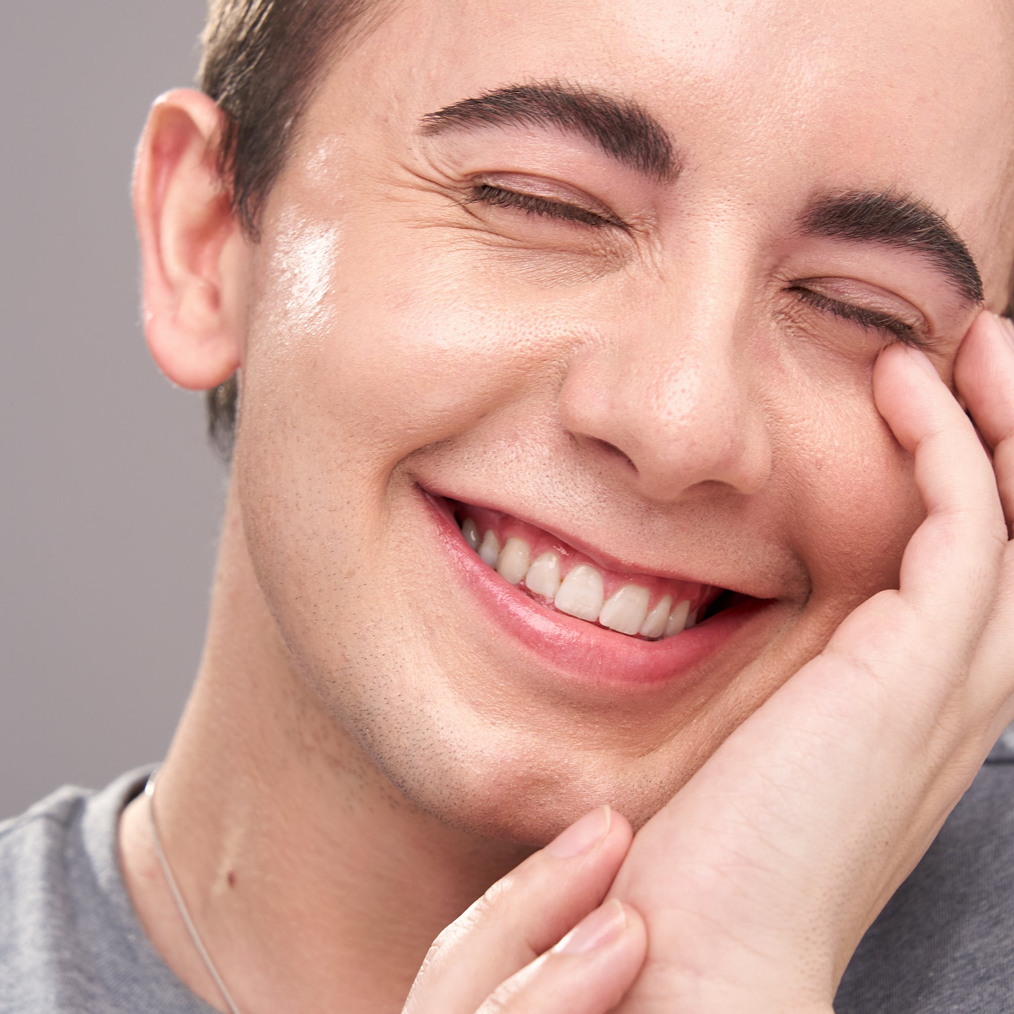 Man smiling with Indie Lee Color Balancer applied on his skin