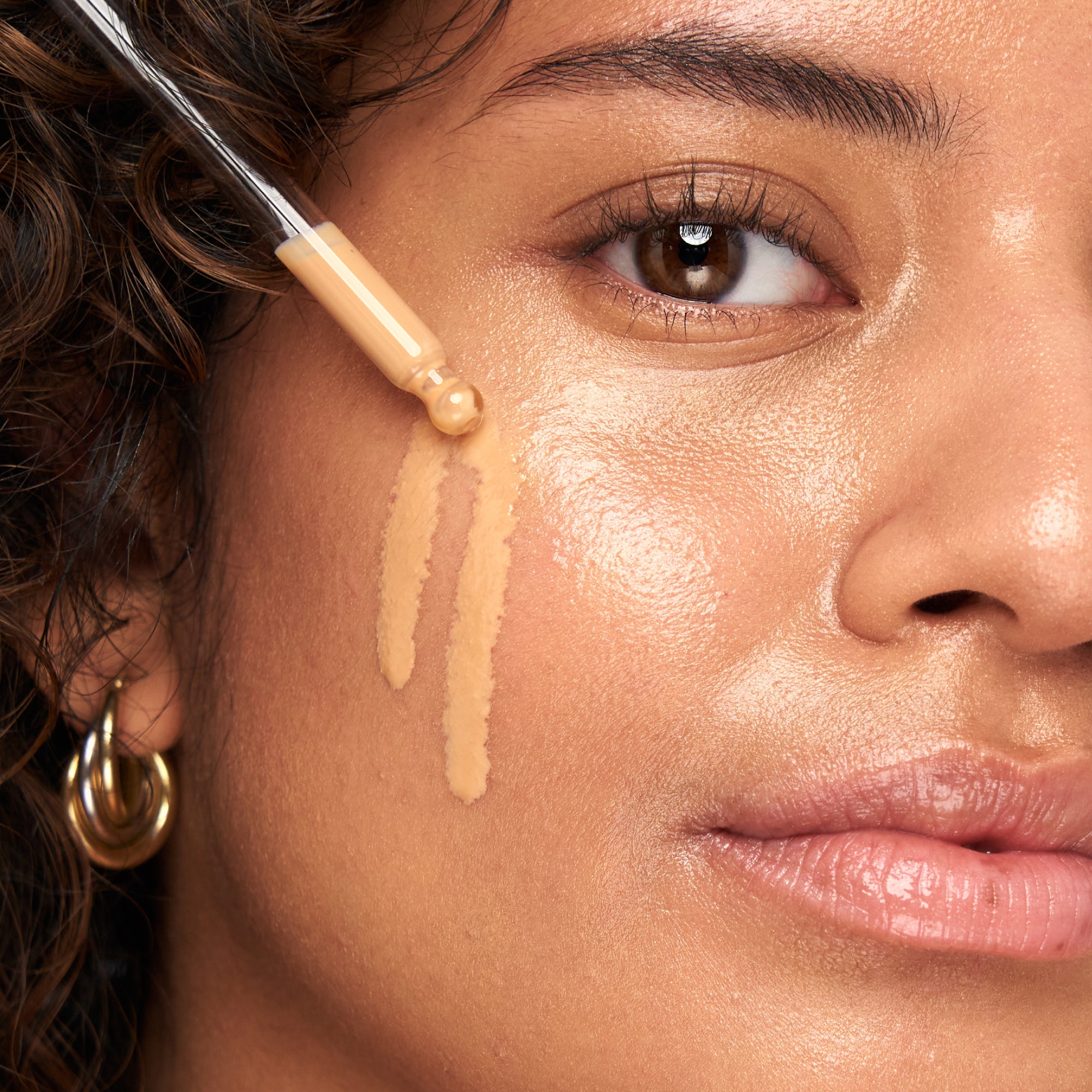 Woman applying Indie Lee SPF 50 Sunscreen Primer to her face